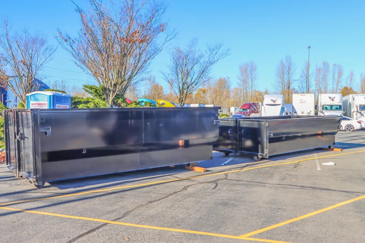 Professional dumpster rental service with roll-off container on residential driveway in Wood Dale